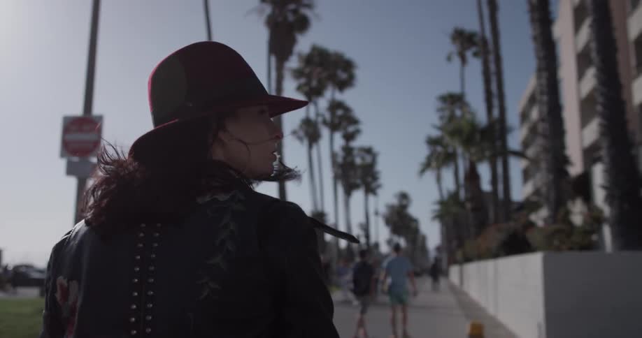 A woman is walking outside during daylight