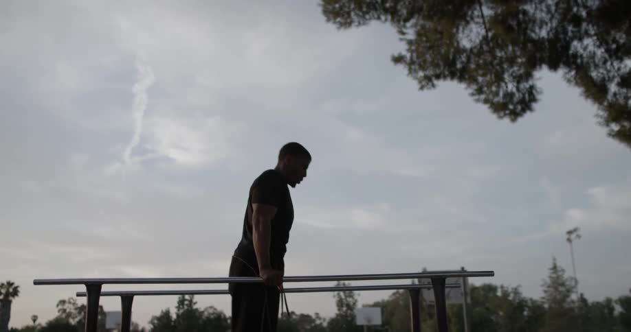 Man working out on beam in afternoon