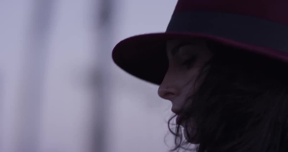 A woman moves back and forth as she listens to music