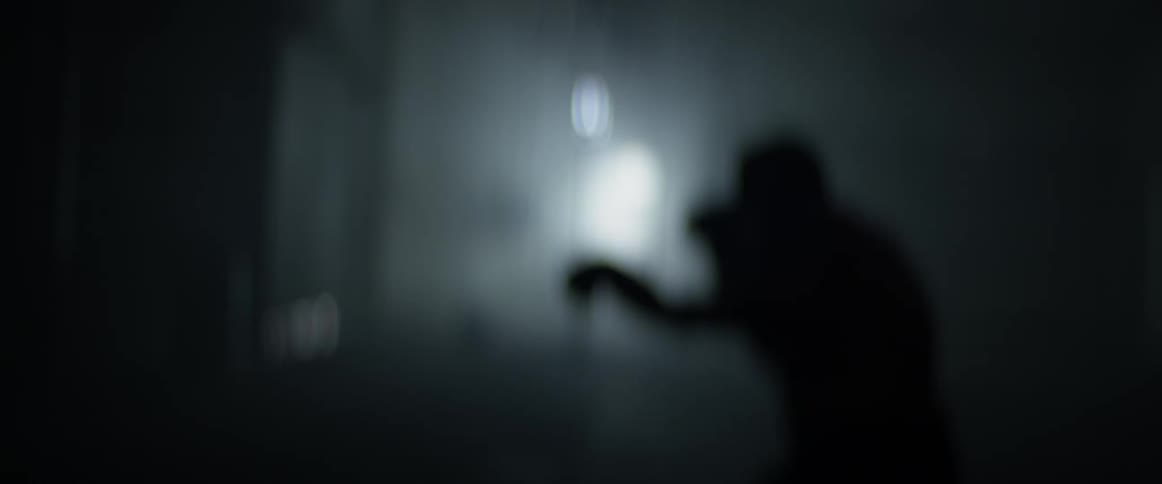 A man with boxing gloves punching in a gym