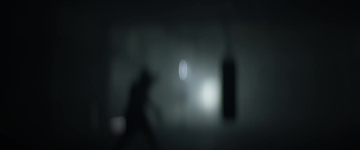A man punching a bag in a gym