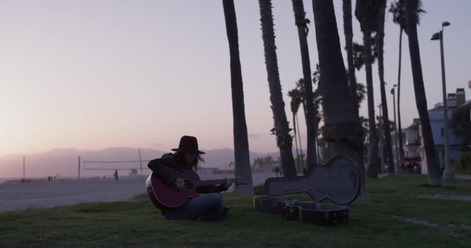 Girl Playing Guitar By The Beach