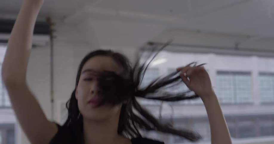 A woman that is dancing in the middle of a dance studio