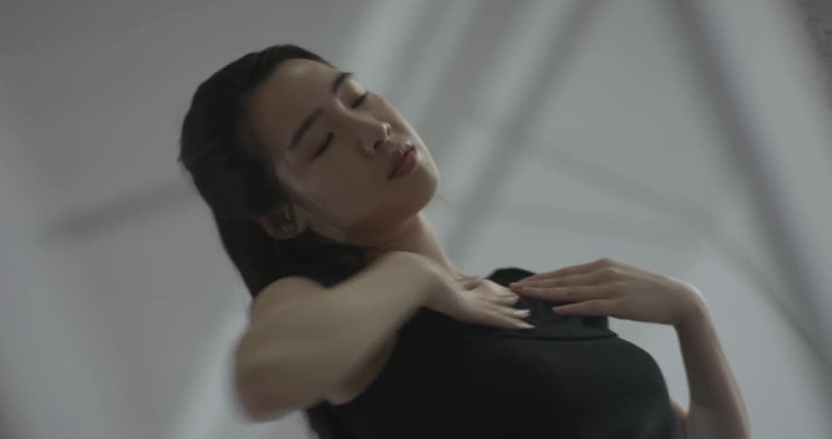 A woman dressed in black is performing a creative dance routine