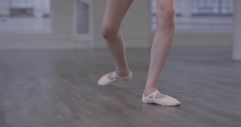 Legs of a ballerina rehearsing a dance