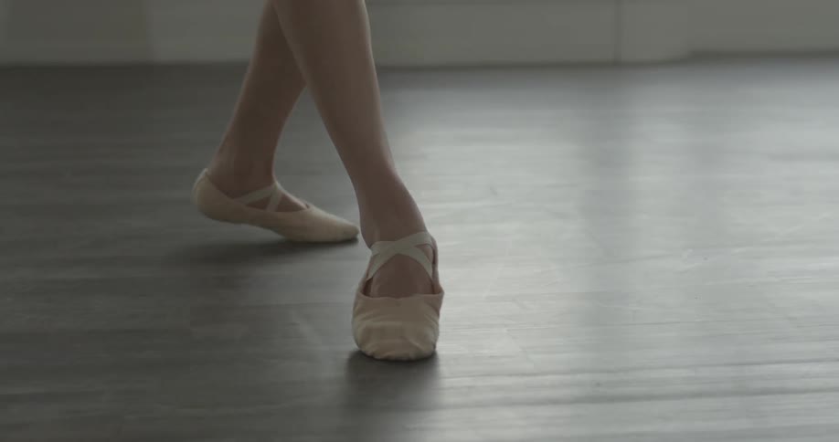 Ballet dancer practicing on wood floor