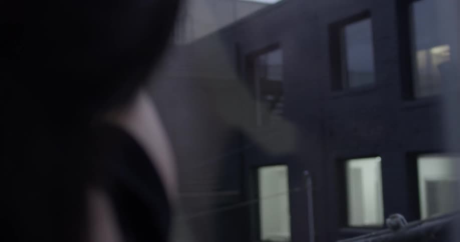 A girl dancing against a glass wall