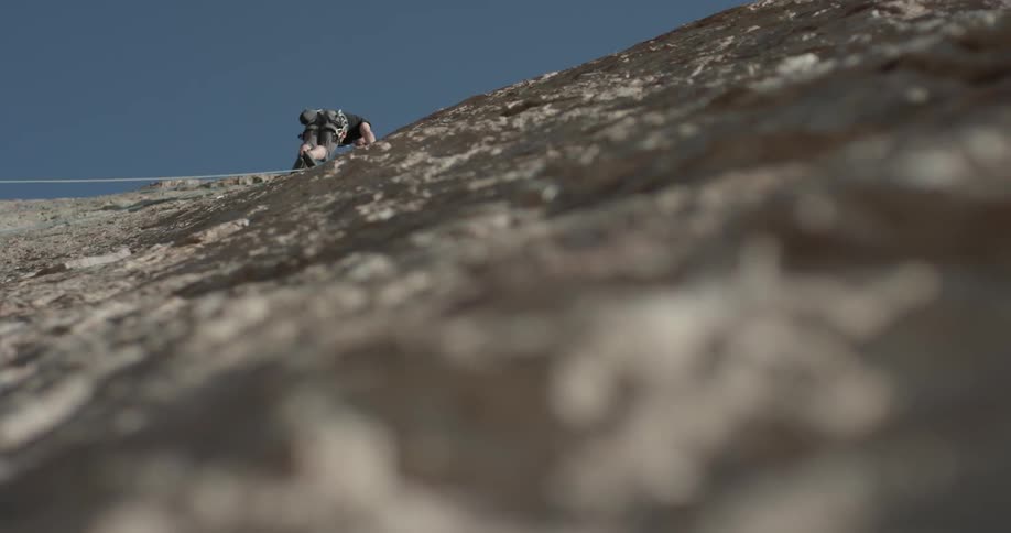 A man climbing up a rock wall