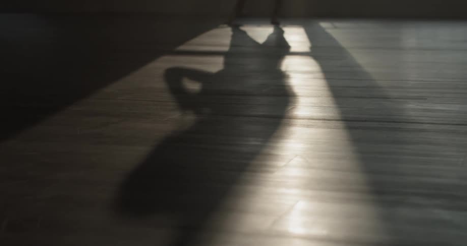 A person that is stretching in front of a window