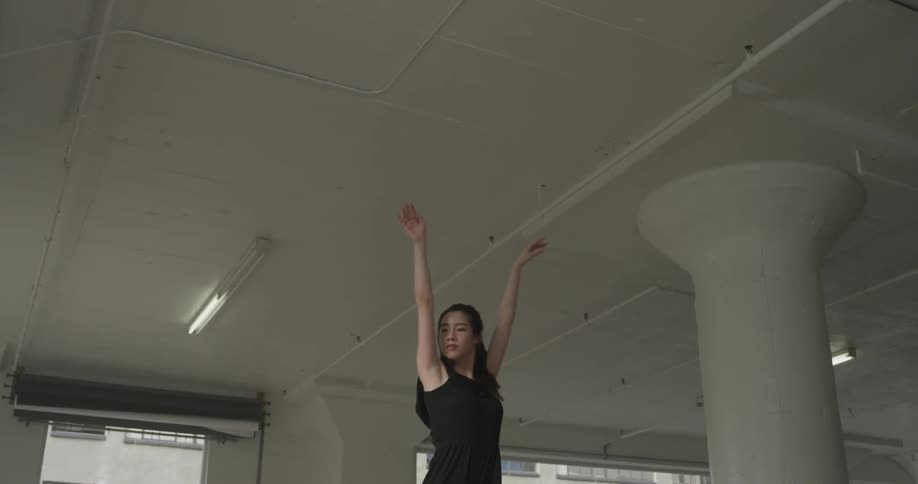 A woman is doing ballet in a room