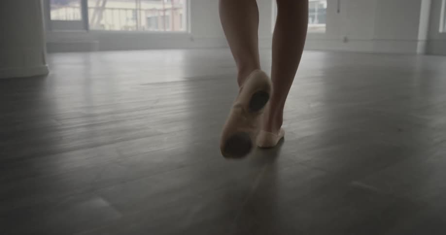 A woman is walking around indoors
