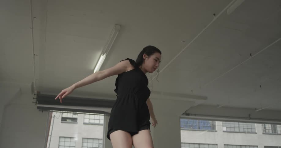 A woman dances in an empty studio