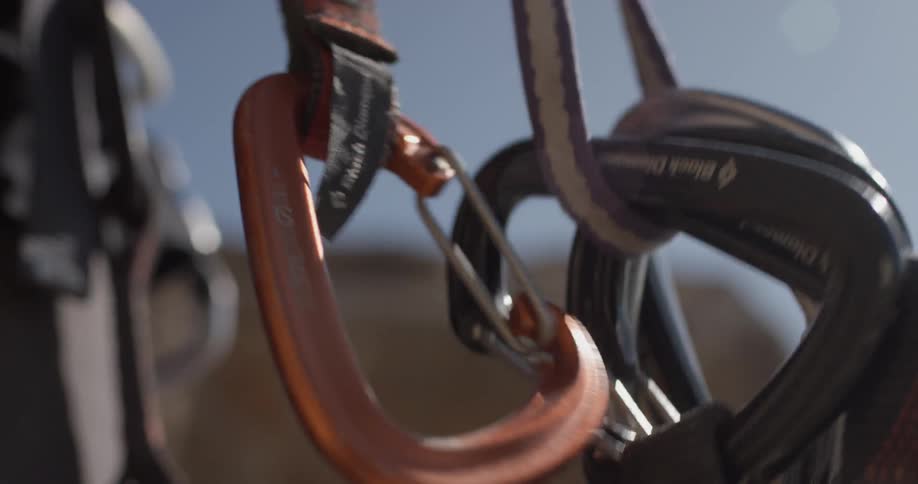 A man attaches quick draws to his belt
