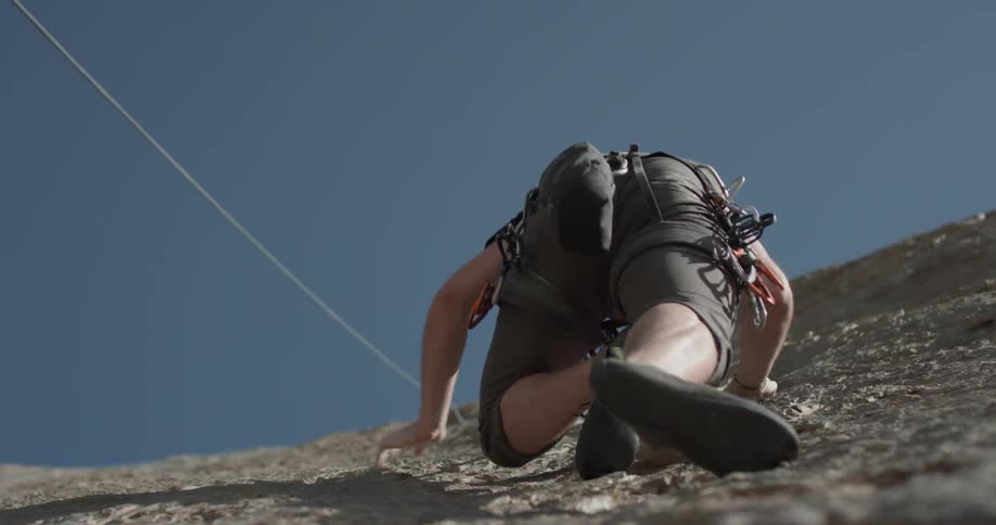 A man scales a mountain