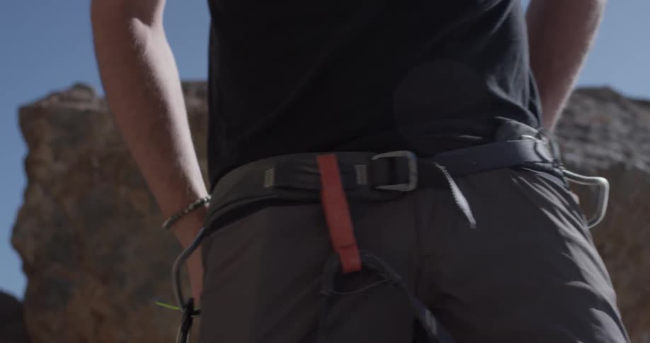 A person puts on climbing gear