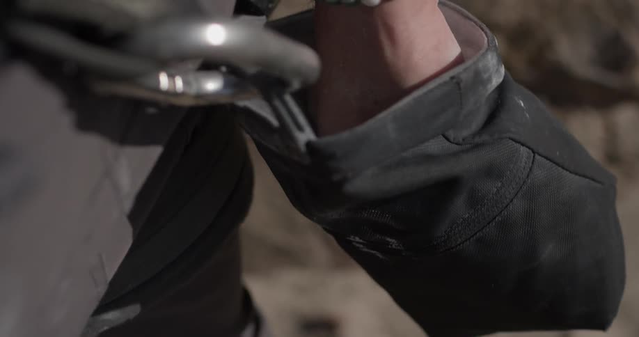 Person with white powder on hands reaches in powdery bag