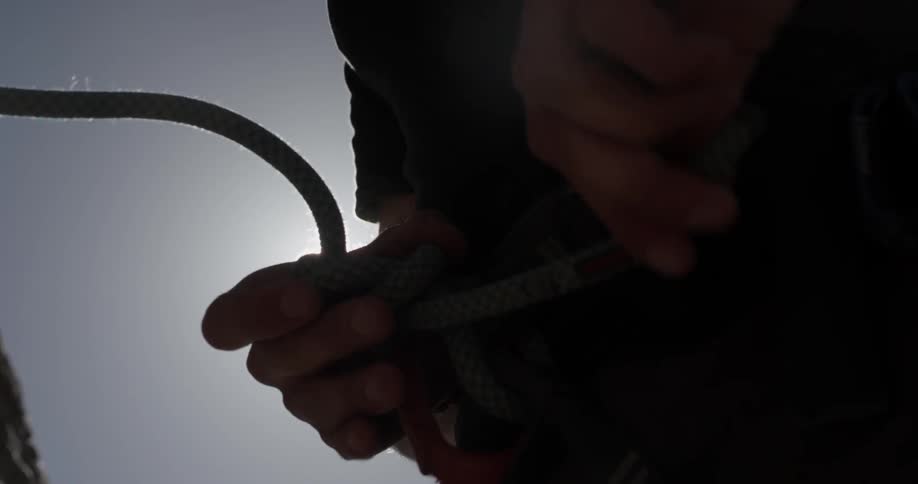 Person connects climbing harness to themselves