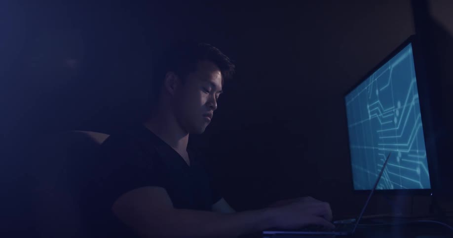Man Coding On Computer In Dark Room