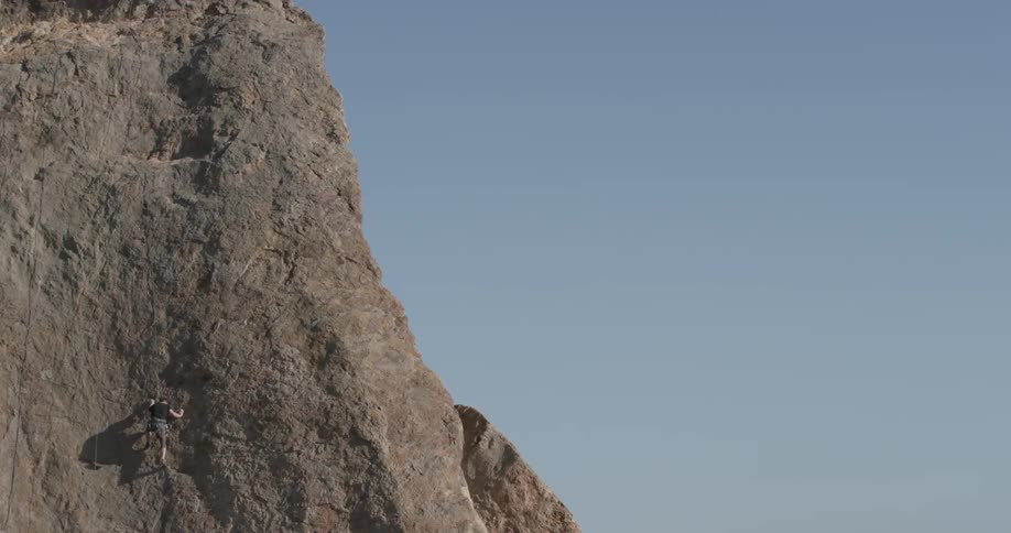 Man Climbing Wall By The Beach