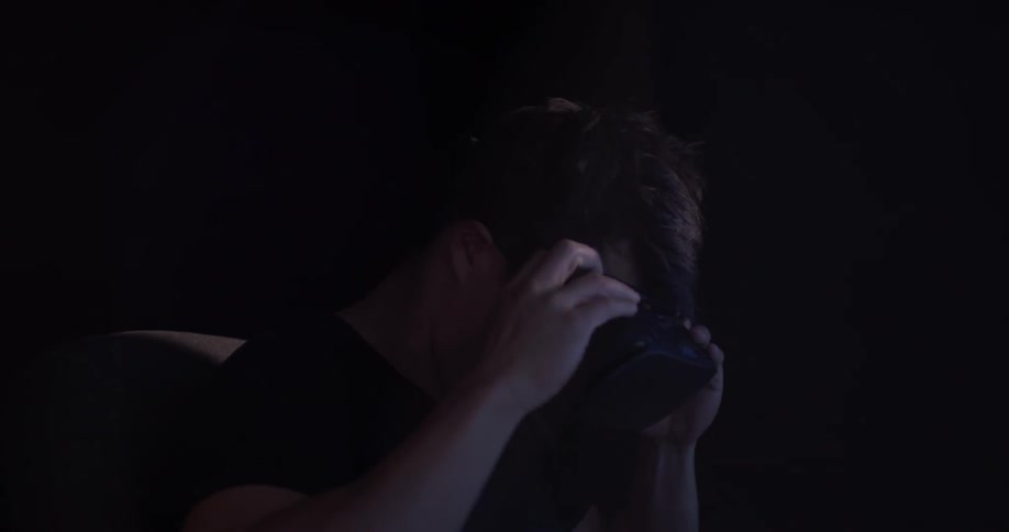 A man uses a vr headset in a dark room
