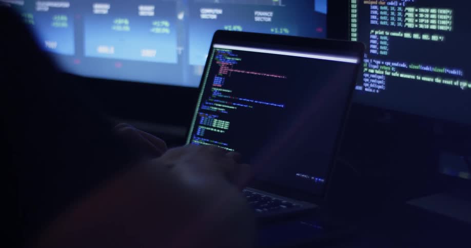 Man Coding On Computer In Dark Room