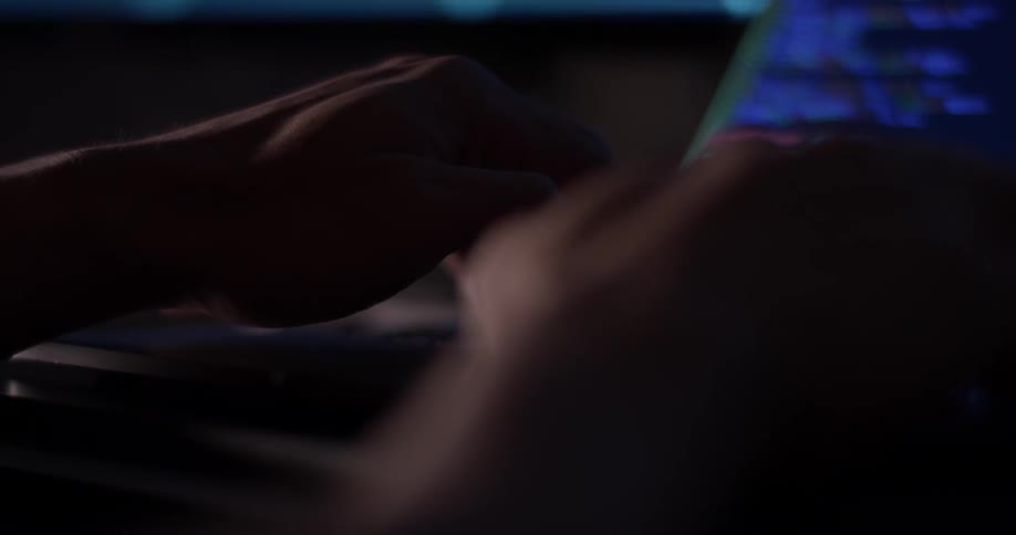 Man Coding On Computer In Dark Room
