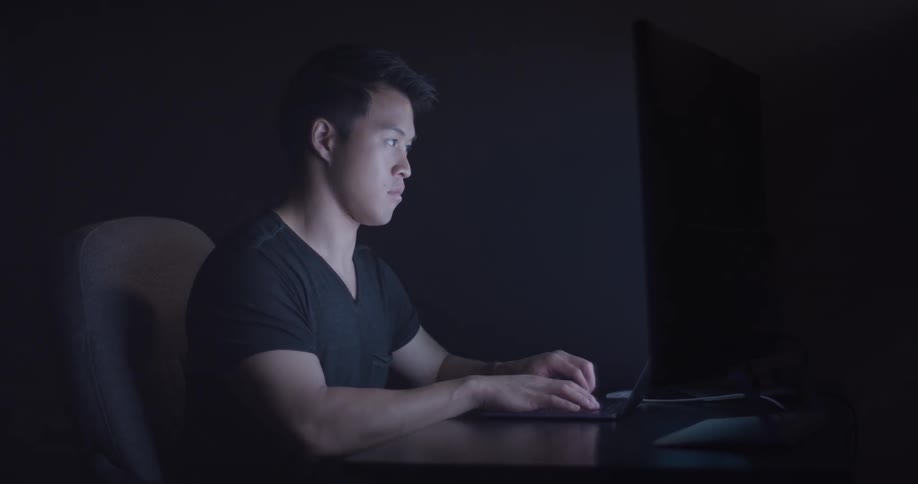 Man Coding On Computer In Dark Room