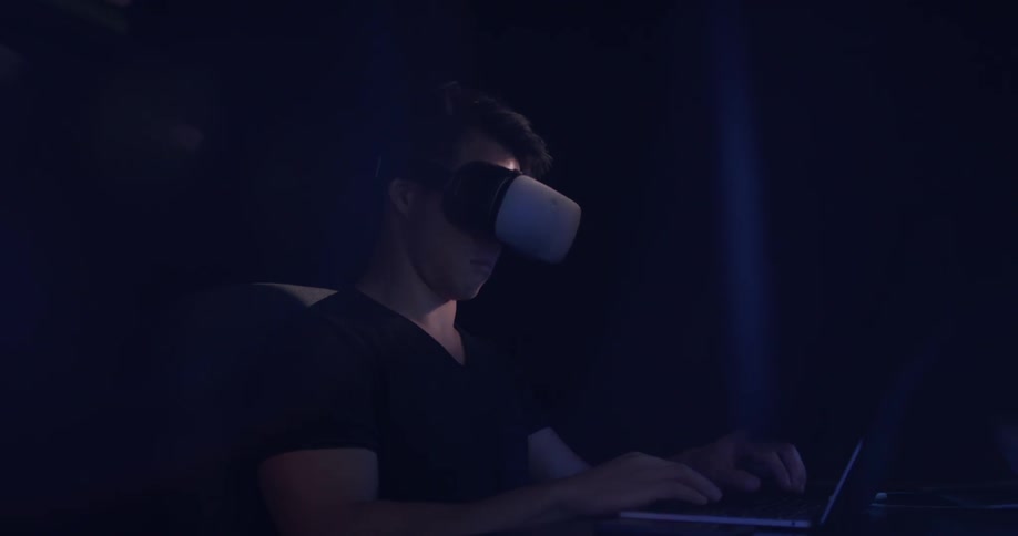 A man looking through some vr goggles in an office
