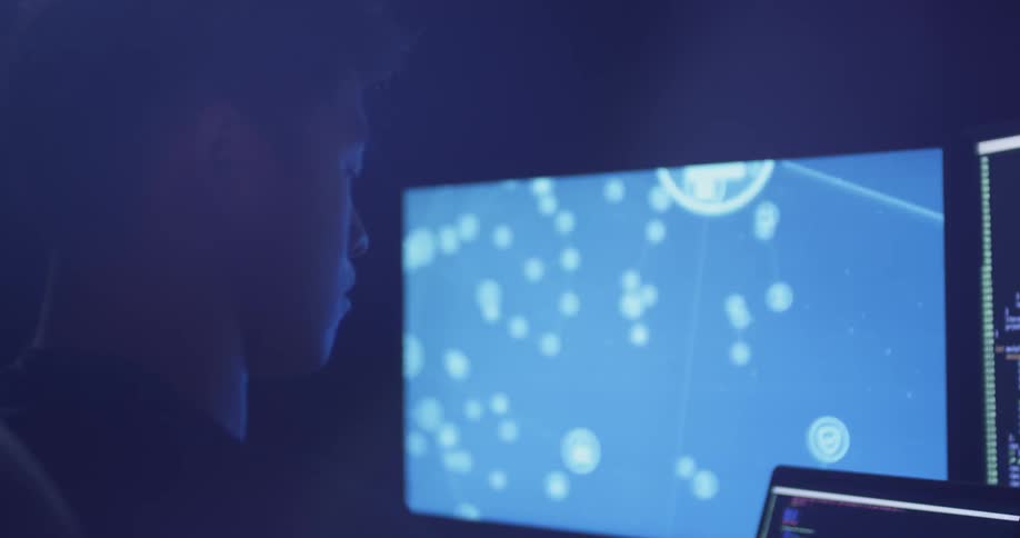A man stares at computer screens