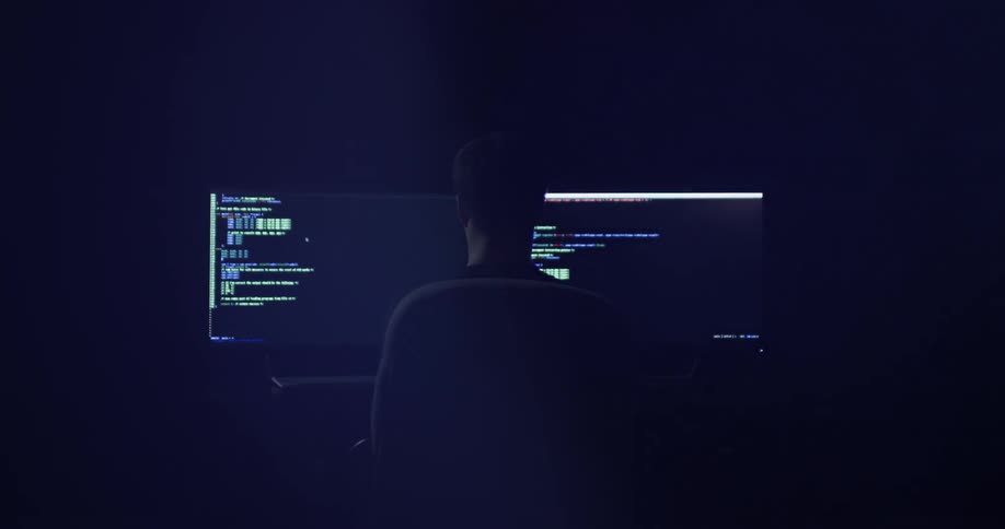 Man Coding On Computer In Dark Room