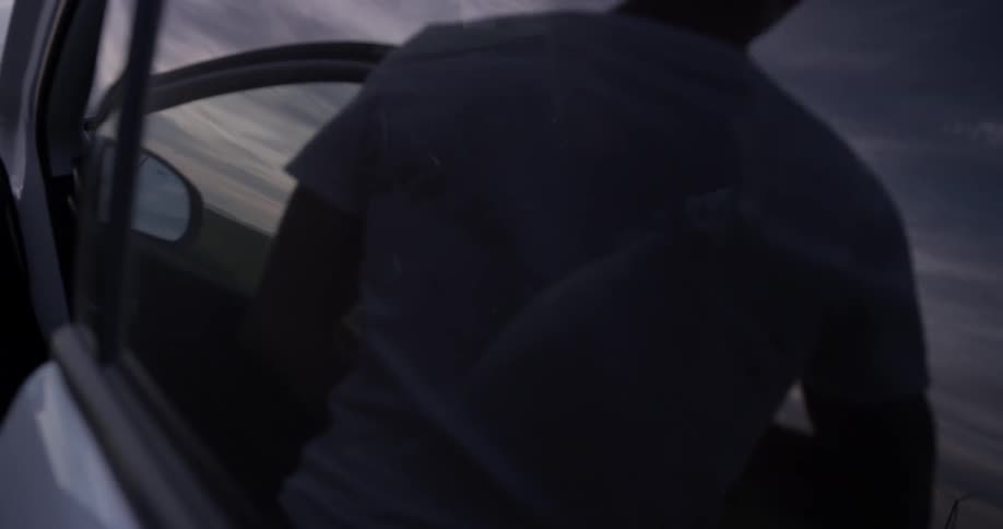 A person opening the door of a car