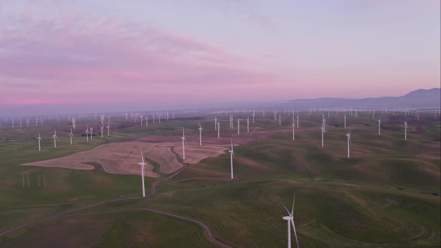 Turbines stretch out for miles across the hills as the wind keeps them turning
