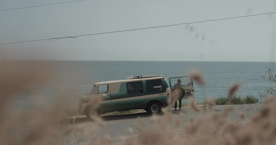 Man unloading a surfboard from his van