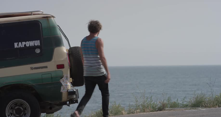 Man Driving To Beach And Surfing