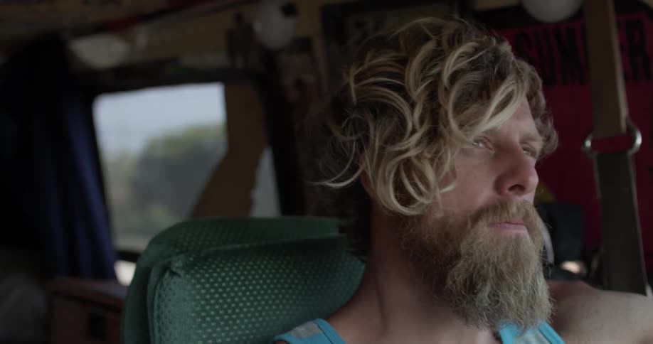 A man driving a van down the road
