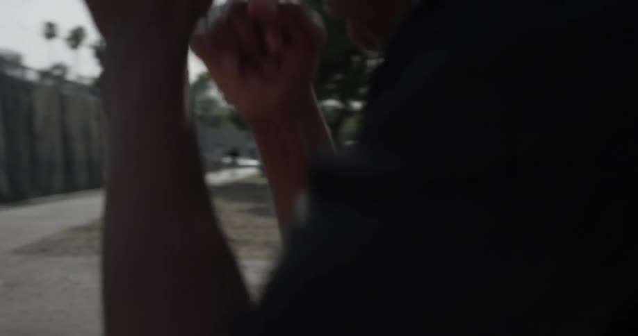 A man wearing headphones punching at the air