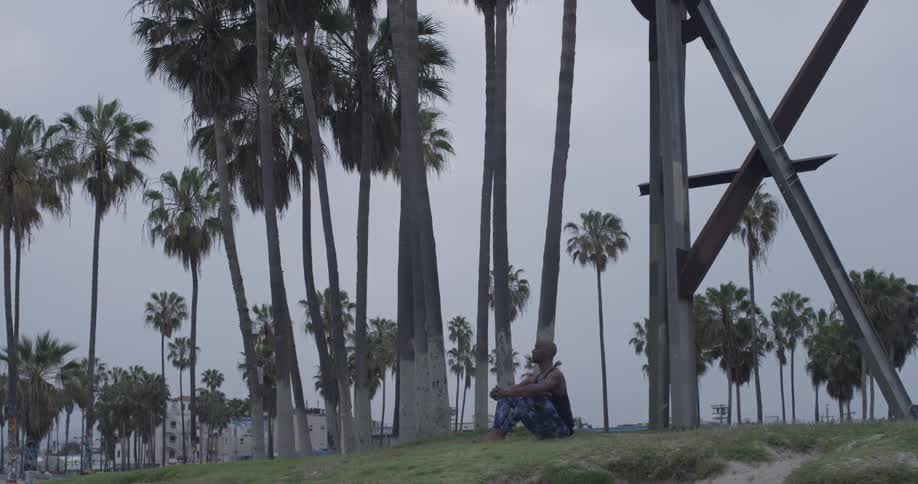 A man sitting on a grassy field meditating