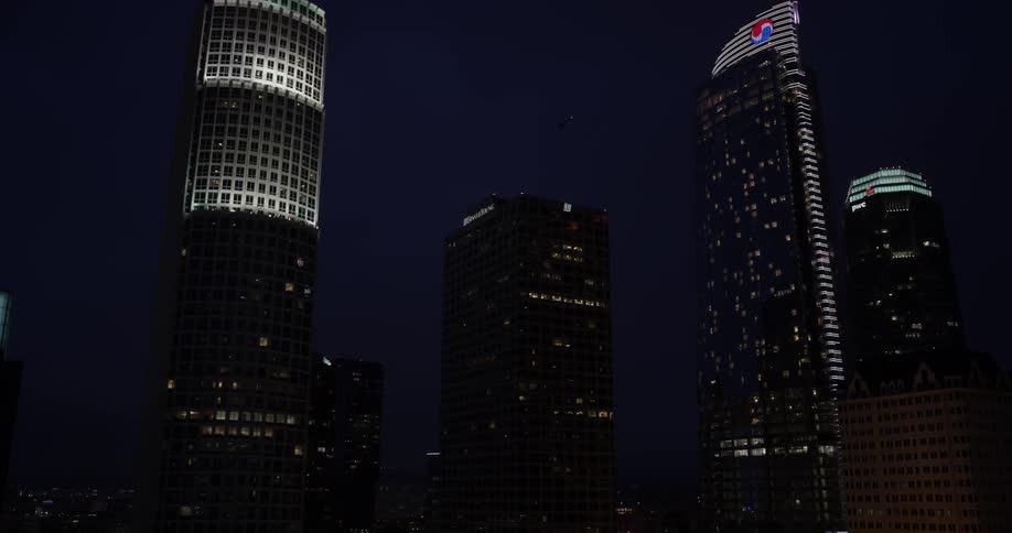 Some buildings in a big city lit up at night