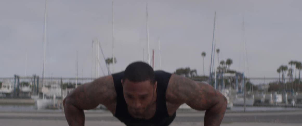 Man does various forms of push ups while outside