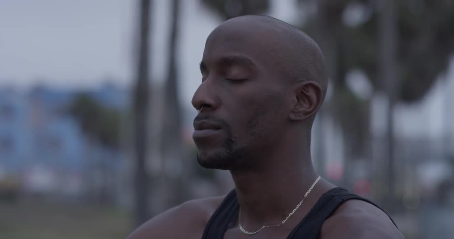 A man meditates on the beach