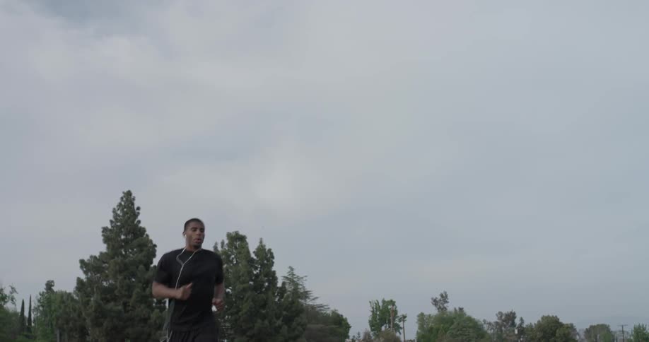 Man jogs in the country on a cloudy day