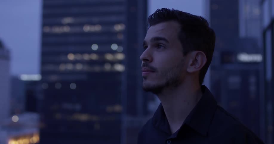 A man looking to the city view and turns around
