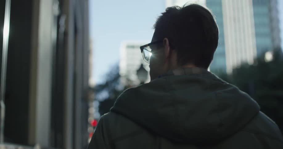 A man walking down an urban street on a cold day