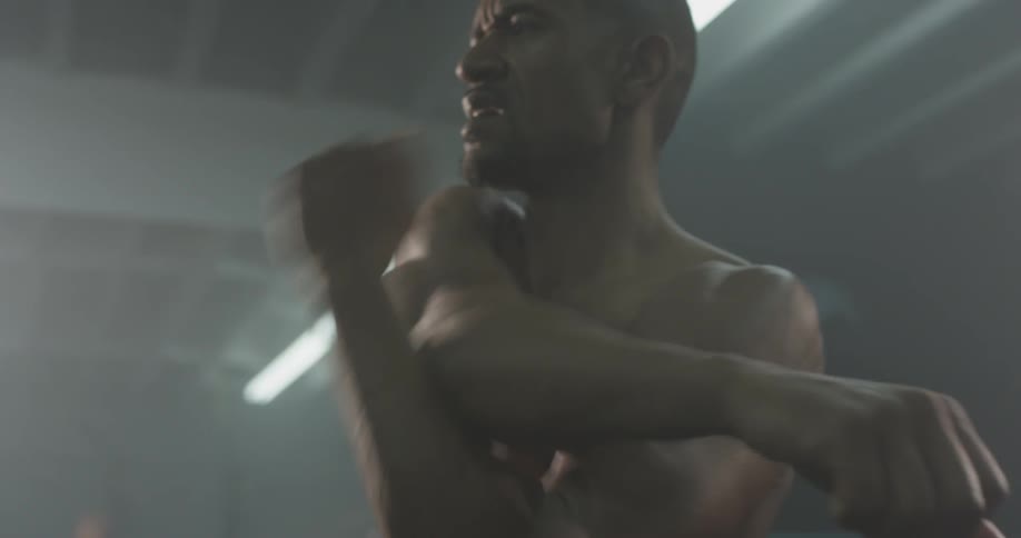 A man stretching before working out in a gym