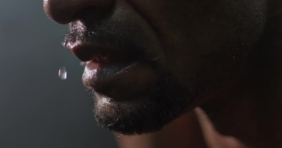 Man's face with sweat coming off nose