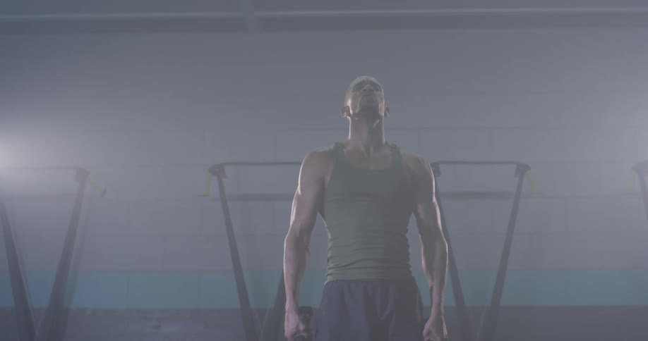 Man slams ropes on the gym floor