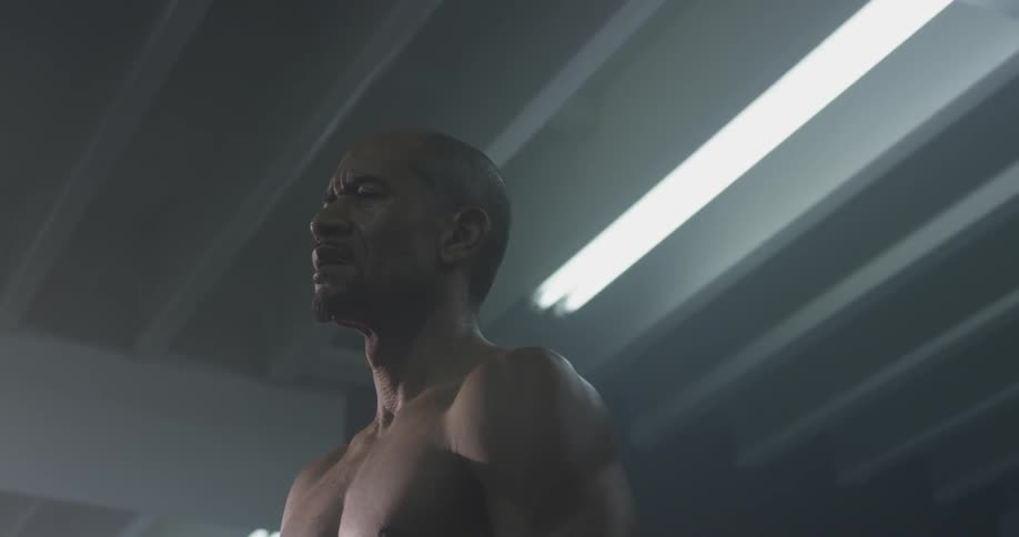 A man sighs from a deep breath and has an angry appearance