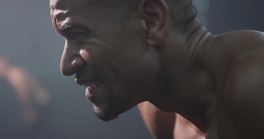 A man is wincing in pain or exhaustion