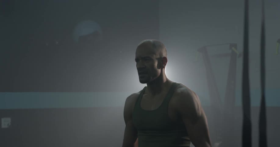 A man shakes his fists and then puts his hands behind his head