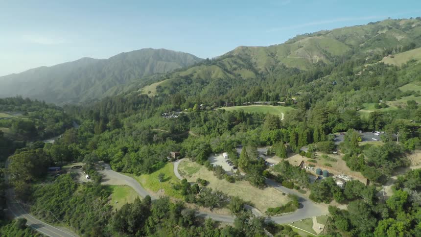 Streets curve through a green hillside